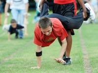 A young man takes part in a wheelbarrow race